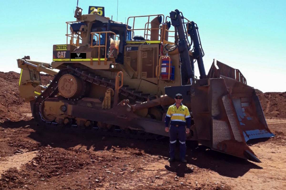ALCMST FOUNDER STANDING NEXT TO DOZER